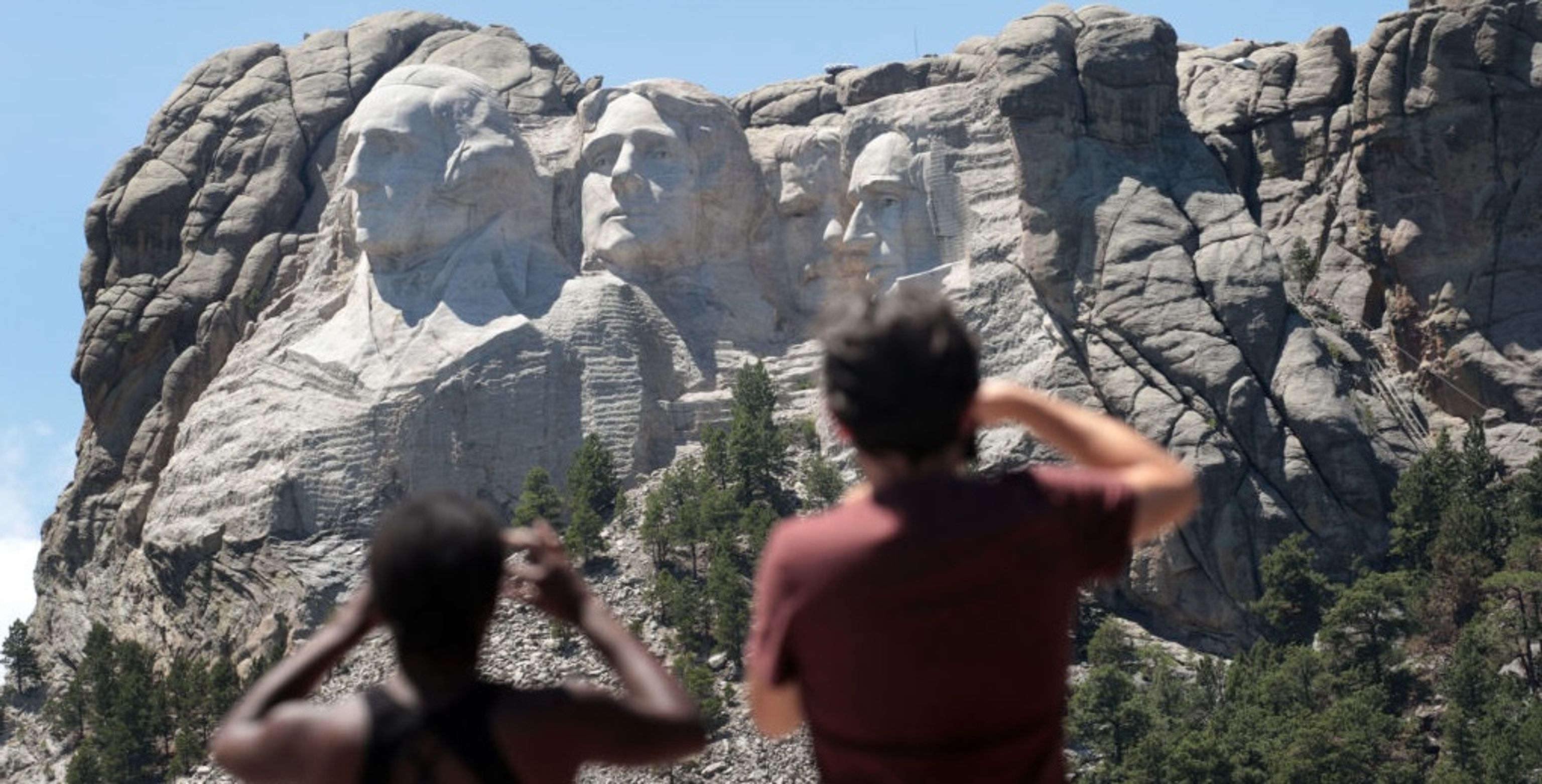 Family enjoying iconic roadside attractions during a road trip